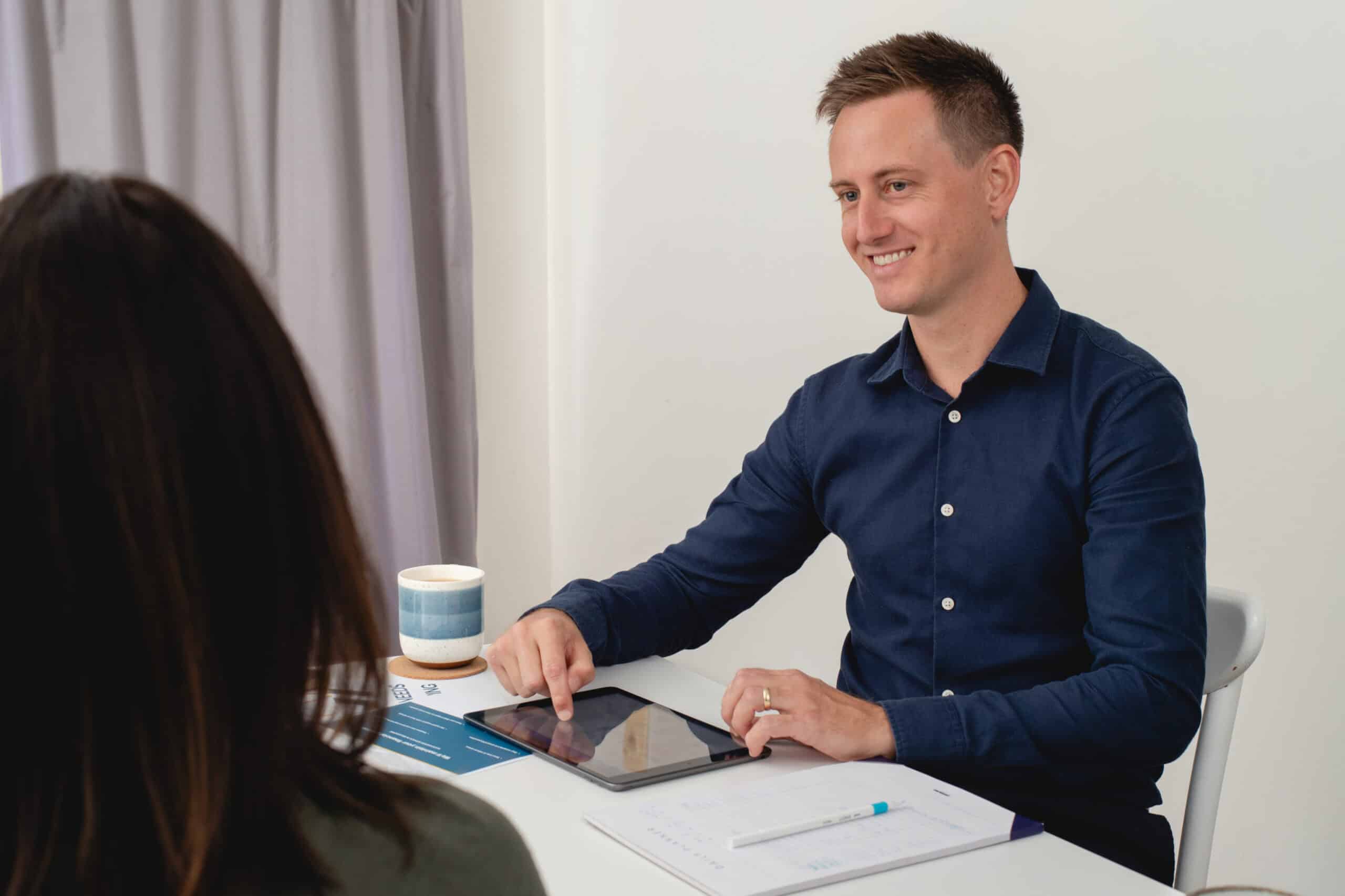 Matthew the bookkeeper talking to a business owner about their financial records